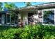 Welcoming porch with comfortable rocking chairs and lush landscaping, creating a cozy and inviting outdoor space at 990 S Jackson St, Denver, CO 80209