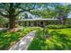 Charming single-story home featuring beautiful landscaping, a spacious front yard, and a welcoming walkway at 990 S Jackson St, Denver, CO 80209