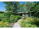 Charming home with lush landscaping, vibrant flowers, and a welcoming walkway leading to the entrance at 990 S Jackson St, Denver, CO 80209