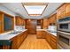 Spacious kitchen with wood cabinets, stainless steel appliances, and skylight at 990 S Jackson St, Denver, CO 80209