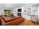 Inviting living room with a cozy fireplace, built-in shelves, and comfortable seating at 990 S Jackson St, Denver, CO 80209