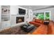 Stylish living room with a fireplace, built-in shelving, and access to the outdoors at 990 S Jackson St, Denver, CO 80209