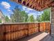 Wooden balcony showing tree top views on a sunny day at 381 S Ames St # G101, Lakewood, CO 80226