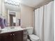 Bathroom with vanity, mirror, and shower/tub combination with white shower curtain at 381 S Ames St # G101, Lakewood, CO 80226