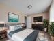Inviting bedroom featuring stylish decor, a large bed, and a wall-mounted TV for relaxation at 381 S Ames St # G101, Lakewood, CO 80226