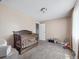Neutral Bedroom with light-colored walls, a wooden crib, and playful toys on the floor at 381 S Ames St # G101, Lakewood, CO 80226