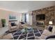 Living room featuring a stone fireplace, contemporary furniture, and large windows at 381 S Ames St # G101, Lakewood, CO 80226