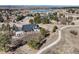 A high angle view shows a home on a large lot with a lake view at 5790 Fox Run Ct, Parker, CO 80134