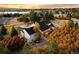 Gorgeous home with a backyard patio, a fire pit, and colorful trees at 5790 Fox Run Ct, Parker, CO 80134