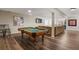 Finished basement featuring pool table, lounge area, hardwood floors and recessed lighting at 5790 Fox Run Ct, Parker, CO 80134