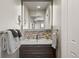 Modern bathroom features a vessel sink, decorative backsplash, and ample storage space at 5790 Fox Run Ct, Parker, CO 80134