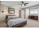 Comfortable bedroom with updated ceiling fan and lighting with views of the beautiful landscape at 5790 Fox Run Ct, Parker, CO 80134