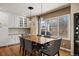 Bright dining room features a wood table, six chairs, and a large window with views of the backyard at 5790 Fox Run Ct, Parker, CO 80134