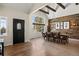 Spacious dining room featuring wood beam ceilings, a wood accent wall, and lots of light at 5790 Fox Run Ct, Parker, CO 80134