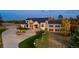 Expansive stone and siding house featuring a circular driveway and professionally landscaped front yard at 5790 Fox Run Ct, Parker, CO 80134