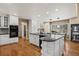 A kitchen island with a granite countertop, white cabinets, and stainless steel appliances at 5790 Fox Run Ct, Parker, CO 80134
