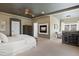Spacious main bedroom features a fireplace, sitting area, and plush carpet, perfect for relaxation at 5790 Fox Run Ct, Parker, CO 80134