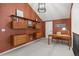 Bright office with wood floors, floating desk and shelves, and neutral carpet offers a cozy workspace at 5790 Fox Run Ct, Parker, CO 80134