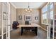 Cozy office with a stylish light fixture and french doors at 5790 Fox Run Ct, Parker, CO 80134