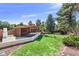 An expansive backyard with deck, covered patio, beautiful landscaping and a built in grill, perfect for entertaining at 326 E Oak Hills Dr, Castle Rock, CO 80108