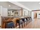 Basement bar featuring a decorative wooden bar, seating, and mirrored shelving at 326 E Oak Hills Dr, Castle Rock, CO 80108