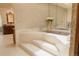 Luxurious bathroom featuring a step-up marble bathtub and elegant fixtures at 326 E Oak Hills Dr, Castle Rock, CO 80108