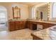 Spacious bathroom with double sinks, wooden cabinetry, and ornate mirrors at 326 E Oak Hills Dr, Castle Rock, CO 80108