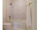 Bathroom featuring marble tile, a shower-tub combination, and gold fixtures at 326 E Oak Hills Dr, Castle Rock, CO 80108