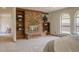 Bedroom featuring a brick fireplace with built-in shelving and arched windows at 326 E Oak Hills Dr, Castle Rock, CO 80108