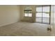 A spacious bedroom featuring carpet flooring, a large window, and a sliding glass door at 326 E Oak Hills Dr, Castle Rock, CO 80108