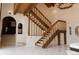 Elegant foyer with a striking staircase, high ceilings, and ample natural light at 326 E Oak Hills Dr, Castle Rock, CO 80108
