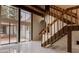 Bright foyer featuring large windows, a grand staircase, and sleek marble floors at 326 E Oak Hills Dr, Castle Rock, CO 80108