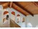 Hallway with wood railing, wood-beam ceiling, and arched openings at 326 E Oak Hills Dr, Castle Rock, CO 80108