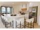 Bright kitchen with a large island, white cabinets, stainless steel refrigerator, and modern appliances at 326 E Oak Hills Dr, Castle Rock, CO 80108