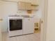 A laundry room featuring modern appliances, upper cabinets, shelving, and a utility sink at 326 E Oak Hills Dr, Castle Rock, CO 80108