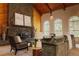 Cozy living room with stone fireplace, vaulted wood ceilings, and lots of natural light at 326 E Oak Hills Dr, Castle Rock, CO 80108