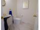 Chic powder room with a pedestal sink, modern toilet, and marble floors at 326 E Oak Hills Dr, Castle Rock, CO 80108