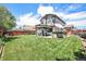 A beautiful backyard featuring a well-maintained lawn, patio, gazebo, and a two-story home in the background at 15776 E 107Th Way, Commerce City, CO 80022