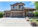 Charming two-story home with a three-car garage and covered front porch at 15776 E 107Th Way, Commerce City, CO 80022
