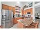 Spacious kitchen with stainless steel appliances, wooden cabinets, and granite countertops at 15776 E 107Th Way, Commerce City, CO 80022