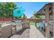 Outdoor kitchen with stone counters, stainless steel grill, and covered seating area at 15776 E 107Th Way, Commerce City, CO 80022