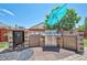 Outdoor kitchen featuring stone surround, stainless steel BBQ, cabinets, and tile flooring at 15776 E 107Th Way, Commerce City, CO 80022
