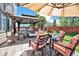 Cozy outdoor seating area featuring a gazebo, comfortable furniture, and a beautifully landscaped backyard at 15776 E 107Th Way, Commerce City, CO 80022