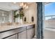 Bathroom featuring dual sinks, granite countertops, and a tiled walk-in shower with glass door at 2078 Wagon Wheel Aly, Brighton, CO 80601