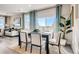 Bright dining room with a large window, seating for four and an open floor plan to the living room at 2078 Wagon Wheel Aly, Brighton, CO 80601