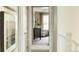 Hallway with carpet flooring leading to a well-lit bedroom and seating area at 2078 Wagon Wheel Aly, Brighton, CO 80601