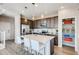 Modern kitchen with stainless steel appliances, an island with seating, and ample cabinet space at 2078 Wagon Wheel Aly, Brighton, CO 80601