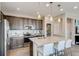 Modern kitchen with stainless steel appliances, an island with seating, and ample cabinet space at 2078 Wagon Wheel Aly, Brighton, CO 80601