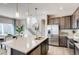 Modern kitchen featuring stainless steel appliances, pendant lighting, and a center island at 2078 Wagon Wheel Aly, Brighton, CO 80601
