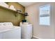 Bright laundry room with modern appliances and ample shelving for storage at 2078 Wagon Wheel Aly, Brighton, CO 80601
